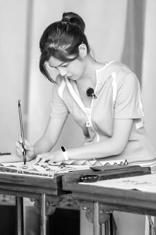 ▲嘉宾在濂溪书院诵读《爱莲说》。 嘉宾陈妍希在体验女书写作。 湖南卫视 供图